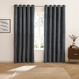 Verso Plain Reversible Eyelet Curtains in petrol blue with a suede-look finish, shown hung on a metal pole in a living room beside a window and wooden cabinet.