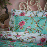 Vintage Chinoiserie Printed Floral Duvet Cover Set in Jade, styled on a bed with matching pillowcases showing pink blooms and birds on a jade green polycotton ground.