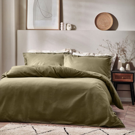 Waffle Cotton Plain Duvet Cover Set in Olive, textured cotton bedding with matching pillowcases on a bed in a neutral bedroom setting.