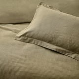 Waffle Cotton Plain Duvet Cover Set in olive, showing the textured cotton weave on the duvet and matching pillowcase with a plain flanged edge on the bed.
