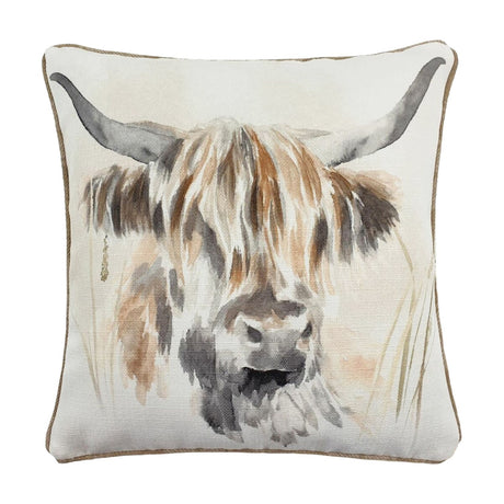 Square polyester cushion featuring a hand-painted watercolour Highland cow with curving horns and shaggy fringe in tan, brown and grey on a cream ground, finished with tan piping.