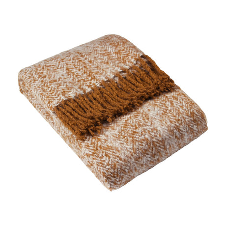 Weaver Geometric Wool Throw in gold, folded to show a herringbone weave in amber and cream with a tasselled fringe edge, on a plain white background.