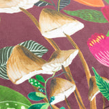 Close-up of the Wild Garden Floral Velvet Cushion in multicolour, showing printed tan-capped mushrooms and pink, orange and green florals on a wine-red velvet ground.