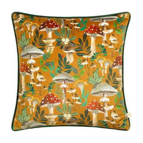 Square velvet-fronted cushion from the Wildgarden Mushroom range, featuring red and white toadstools, parasols and chanterelles amid green foliage on an amber-gold ground with dark green piping.