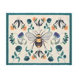 Rectangular woven polyester placemat with a central bumblebee on a cream ground, framed by mirrored orange, teal and blue florals and a deep teal border, shown on a plain white background.