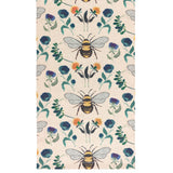 Wild Garden polyester table runner in cream, woven with large bumblebees, blue and purple blooms, orange flowers and green foliage in a repeating multicolour pattern.