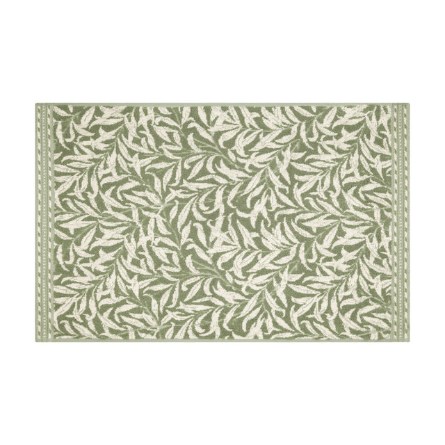 Rectangular cotton bath mat in the Willow Boughs design, sage green leaf pattern on cream ground with a narrow banded border, shown on a plain white background.