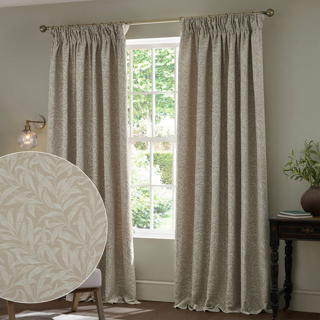 Willow Boughs jacquard linen pencil pleat curtains in beige with a woven leaf pattern, shown pleated at a window in a living room, with a fabric swatch inset.