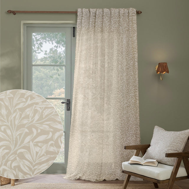 Willow Bough Floral Linen Curtain Panel in cream, hanging beside a glazed door with a matching cushion on a nearby armchair, plus a fabric swatch inset.