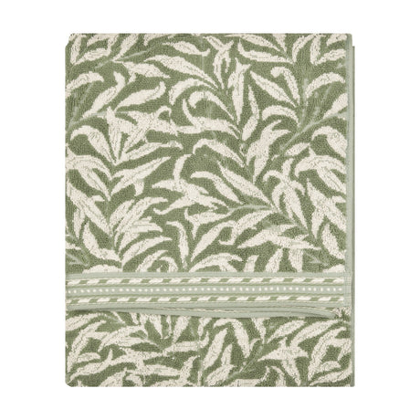 Folded Willow Boughs jacquard cotton towel in sage green with a trailing willow leaf pattern and striped border, shown on a plain white background.