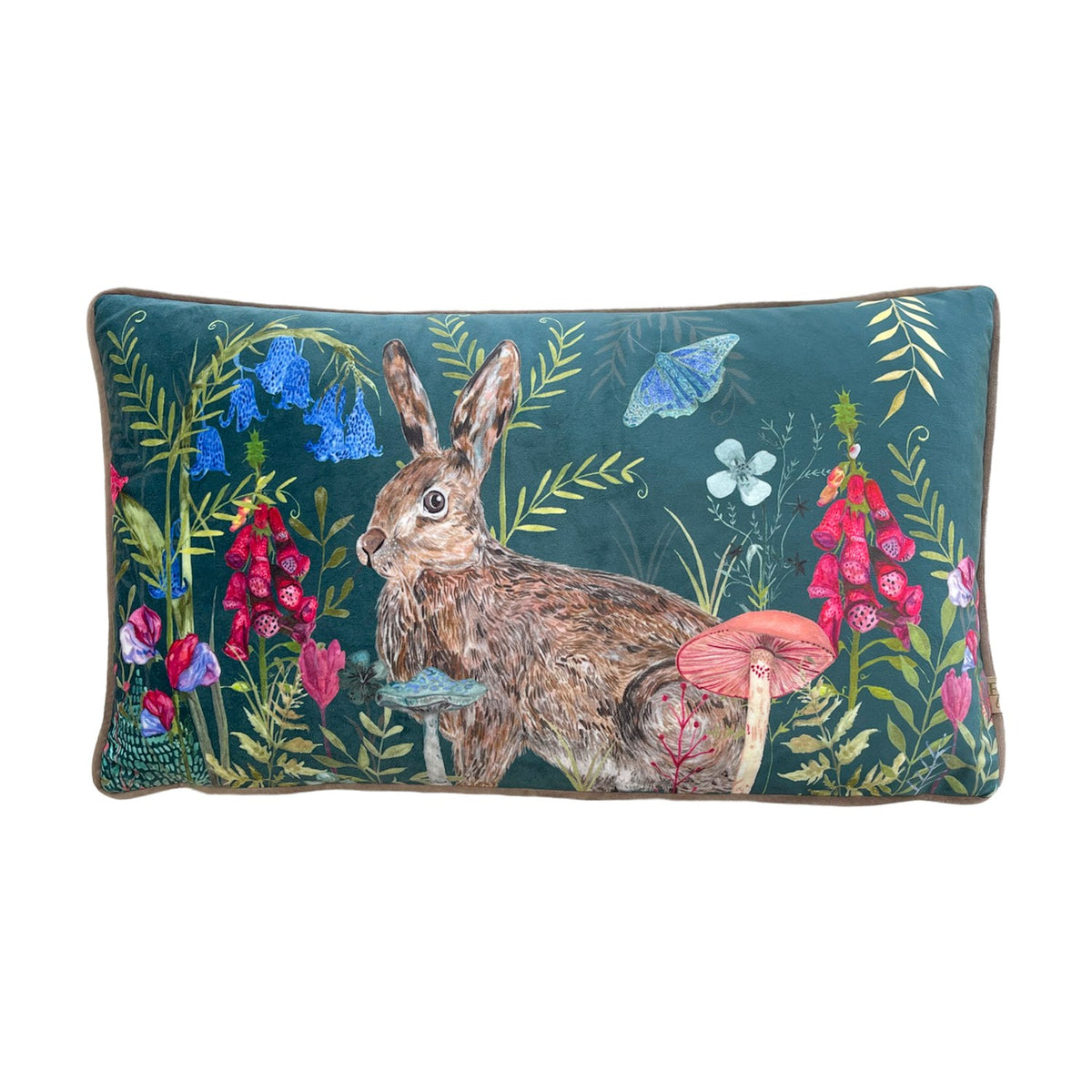 Willow Animal Velvet Cushion in multi colourway, rectangular with a hand-painted rabbit amid bluebells, foxgloves and toadstools on a deep teal velvet ground, shown on a white background.