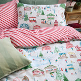 Reversible cotton duvet cover set with a festive fairground and Christmas tree print on one side, red-and-cream candy stripes on the other, plus matching pillowcase.