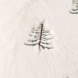Close-up of the Winter Pines Woodland Polyester Throw in ecru, showing soft fleece fabric with a raised embroidered pine tree in green and brown thread.