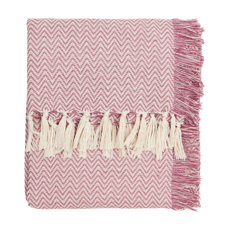 Wisley Herringbone Polyester Throw in heather pink, folded with cream tasselled fringe on one edge, shown on a plain white background.