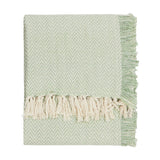 Wisley Herringbone Polyester Throw in leaf green, folded to show chevron weave texture and cream knotted tassel fringe, on a plain white background.