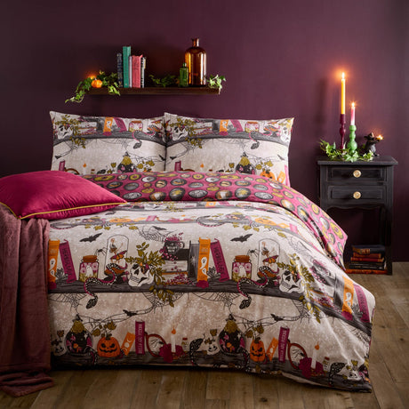 Multicoloured Witchy Tales reversible duvet cover set with Halloween shelf print of skulls, jars, pumpkins and cobwebs in cream, gold, orange and pink, styled on a bed in a dark purple room.