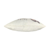 Side view of the Woodland Animal Linen Cushion showing its slim seam edge in natural linen with a partial hare motif and script visible, on a plain white background.