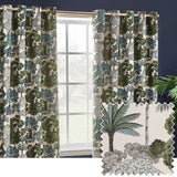Green Woodlands jacquard eyelet curtains, fully lined, with a woven scene of trees, palms and foliage in green, teal and grey on cream, shown by a window with a fabric swatch.