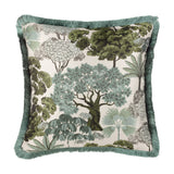 Woodlands Eyelet Velvet Cushion in green, square jacquard design with woven tree canopy scene in green, sage and grey on cream ground, finished with teal fringe trim, shown on a white background.