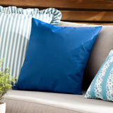 Plain Printed Polyester Cushion in royal blue on an outdoor sofa, shown beside striped and floral patterned cushions on a garden bench.