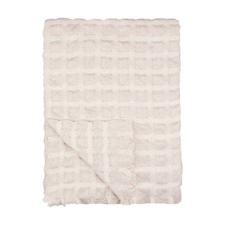 Walton Waffle Check Linen Throw in cream, folded to show its waffle-weave grid pattern and fringed edge, on a plain white background.