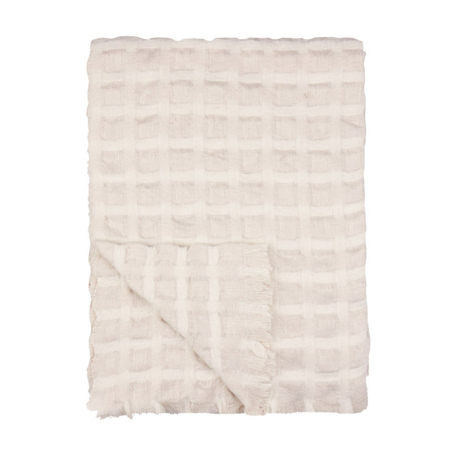 Walton Waffle Check Linen Throw in cream, folded to show its waffle-weave grid pattern and fringed edge, on a plain white background.