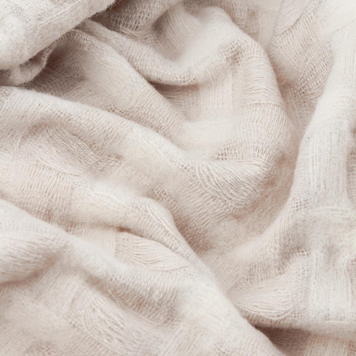 Close-up of the Walton Waffle Check Linen Throw in cream, showing its raised waffle-weave texture in soft folds.