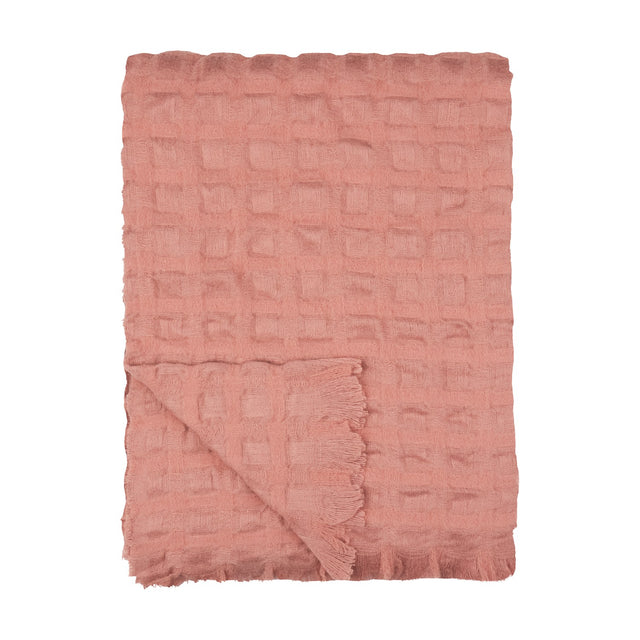 Walton Waffle Check Polyester Throw in rose pink, folded to show its raised waffle grid texture and fringed edge, on a plain white background.
