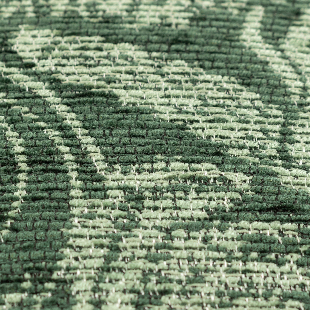 Close-up of the Winter Woods Jacquard Chenille Cushion in emerald, showing a woven two-tone forest scene of deer, hare, and branching trees in the textured fabric.