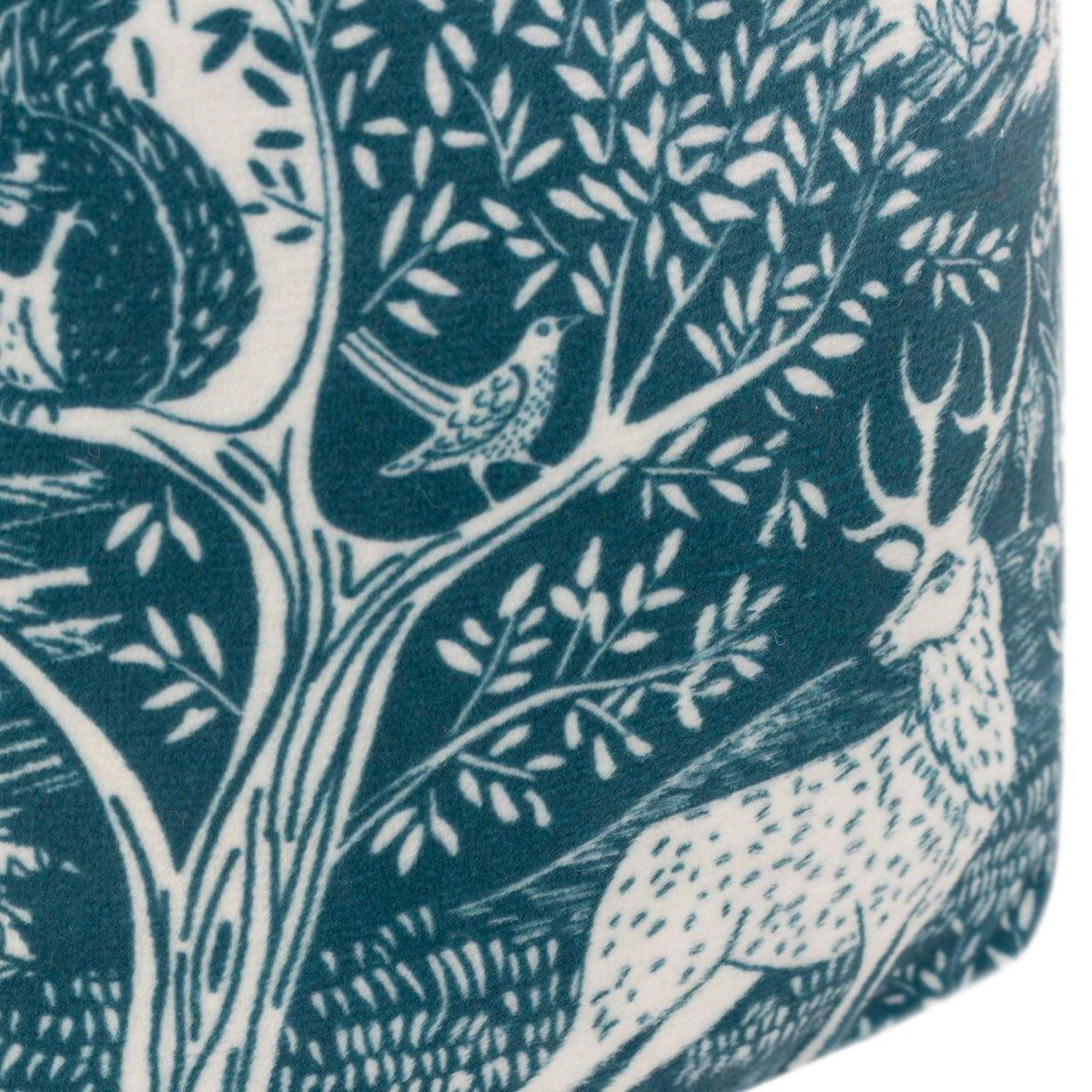 Close-up of the Winter Woods Animal Velvet Door Stop in midnight blue, showing a cream woodblock-style print of a stag, bird and tree branches on velvet fabric.
