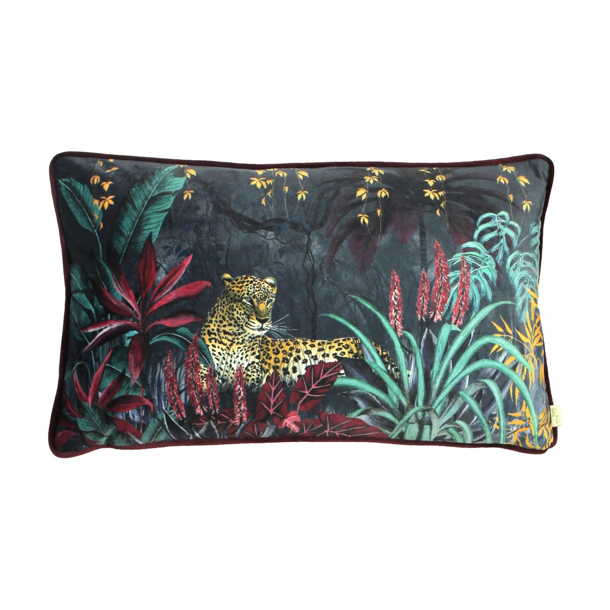 Zinara rectangular velvet bolster cushion in black, printed with a hand-painted jungle scene of a leopard among banana leaves and red aloes, wine-red velvet reverse, shown on a white background.