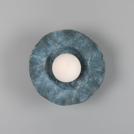 Rivale Ceramic Globe Wall Light in Blue Earth, a round ceramic shade with a ruffled, wavy rim in mottled blue glaze encircling a central white glass globe, shown against a plain grey background.