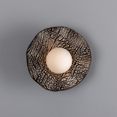 Rivale Ceramic Globe Wall Light with ruffled Black Clay ceramic shade and crackle glaze, opal glass globe centred within, shown on a plain grey background.