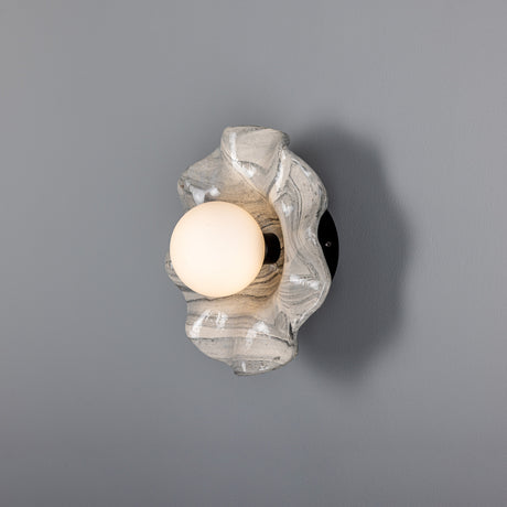 Rivale Ceramic Globe Wall Light IP44 in Marbled grey-white glaze, a wavy ceramic dish holding a single frosted glass globe, shown lit on a plain grey background.