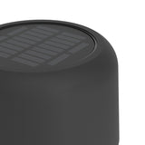 Close-up of the Roccanova-L solar LED floor lamp's cylindrical black steel head, showing the ribbed solar panel set into the top surface, on a plain white background.