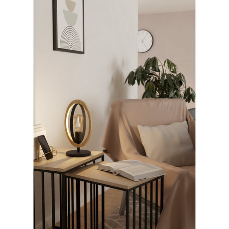 Rolmanne Table Lamp 34.5cm in black and brown, with nested oval wood and steel rings on a round base, styled on a nesting side table in a living room.