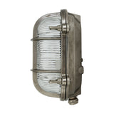 Ruben Small Bulkhead Wall Light in aged silver, side view showing oval ribbed glass, cage bars, fixing lugs and cable gland, on a white background.