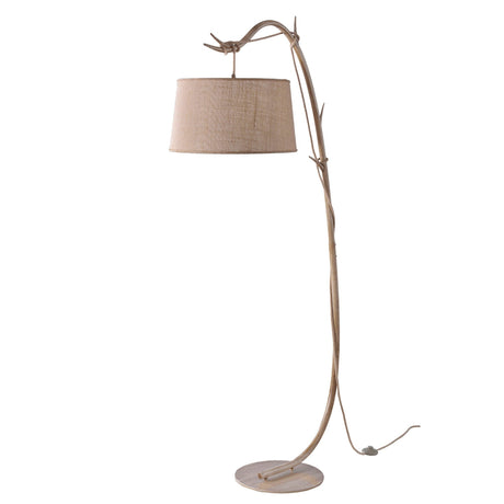 The Sabina 1 Light Floor Lamp features a natural, branch-like brown wooden stem on a round base with a beige linen shade and exposed cord—ideal for adding rustic flair to bohemian spaces.