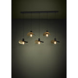 Saceda Linear Pendant Light in black and gold, with five hat-shaped steel shades at staggered heights along a black ceiling bar, each shade's gold-lined underside catching the bulb glow.
