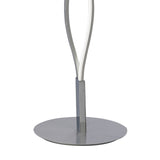 A close-up of the Sahara LED Floor Lamp 21W 3000K in Silver & Chrome features a round, flat base with two sleek, curved metal rods—an elegant choice for adding ambient lighting to any room.