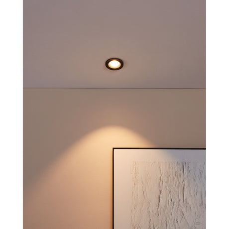 Salabate LED Downlight 6W in black recessed into a ceiling, casting a warm-white beam onto a wall beside a framed artwork.