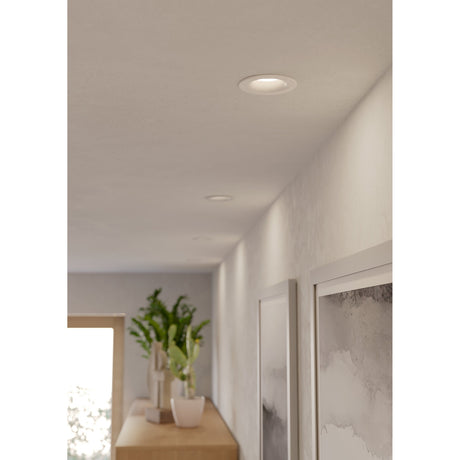 Salabate LED downlight set of 3 in white with round aluminium trim, shown recessed into a hallway ceiling alongside artwork and a plant-topped console table.