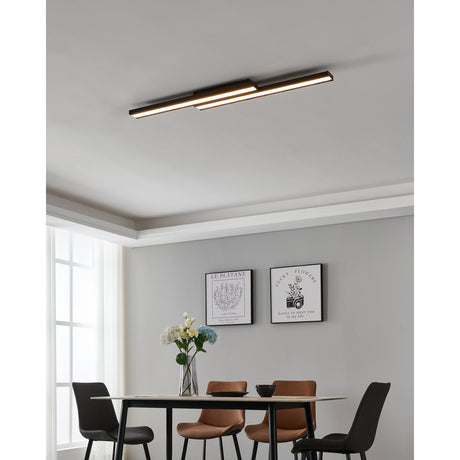 Saliteras Smart Colour Changing LED Flush Ceiling Light in black steel with two offset linear bars and white diffusers, shown mounted on a dining room ceiling.