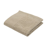 Sanchore Placemat in beige, a folded rectangular woven cotton mat with a finely ribbed border and textured basket-weave centre, shown on a plain white background.