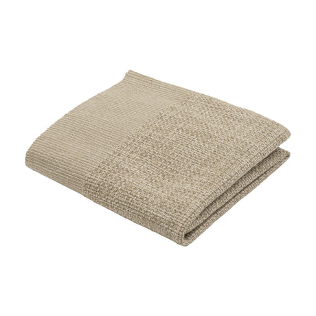 Sanchore Placemat in beige, a folded rectangular woven cotton mat with a finely ribbed border and textured basket-weave centre, shown on a plain white background.