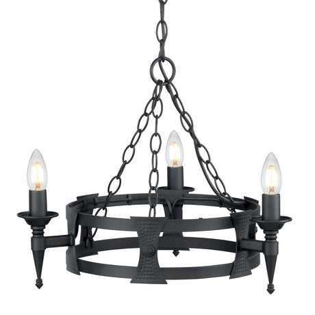 The Saxon 3 Light Chandelier - Black is suspended from a chain and exudes a medieval-inspired design. Featuring a circular frame, it holds four candle-like bulbs on spiked holders, capturing the essence of traditional and rustic aesthetics with its black wrought iron construction.