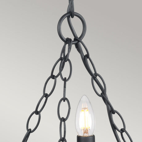 A close-up of a vintage-style light fixture featuring a single exposed bulb that brings to mind the Saxon 3 Light Chandelier - Black. The bulb is encircled by ornate interlocking wrought iron chains, creating a medieval aesthetic, all against a simple gray background.