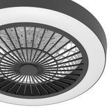 Close-up of the black and white Sazan ceiling fan with light, featuring a black radial grille, milky acrylic diffuser ring, and black outer band on a plain white background.