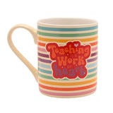 Porcelain mug with cream handle, featuring rainbow horizontal stripes and a red badge reading "Teaching is a work of heart" in retro lettering, shown on a white background.