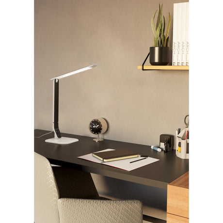 Sellano LED touch table lamp in white and black, with slim flat head and hinged arm on a glossy white base, shown on a dark desk beside a clock.
